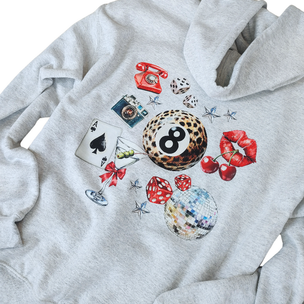 Unleash your inner luck and style with our Leopard 8 Ball Lucky Collage Hoodie. This trendy hoodie features a unique design of animal print, lucky symbols, and y2k style elements like dice, cherries, and disco balls. Perfect for a preppy aesthetic look, size up for an oversized fit.
