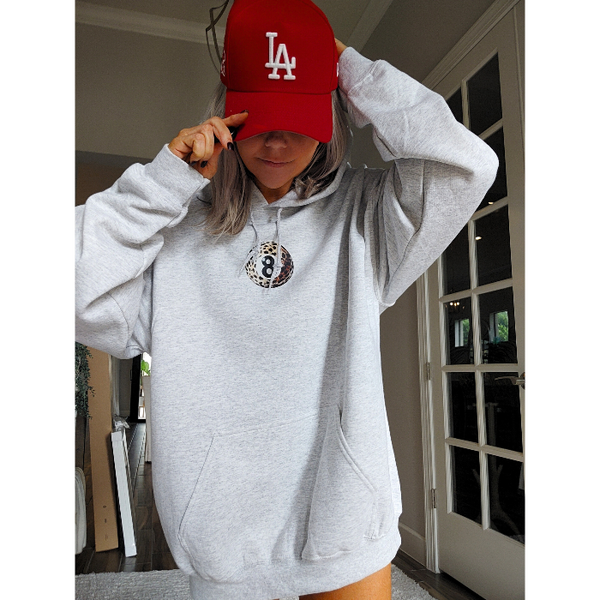 Unleash your inner luck and style with our Leopard 8 Ball Lucky Collage Hoodie. This trendy hoodie features a unique design of animal print, lucky symbols, and y2k style elements like dice, cherries, and disco balls. Perfect for a preppy aesthetic look, size up for an oversized fit.