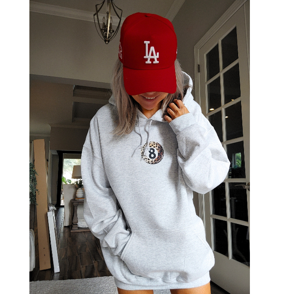 Unleash your inner luck and style with our Leopard 8 Ball Lucky Collage Hoodie. This trendy hoodie features a unique design of animal print, lucky symbols, and y2k style elements like dice, cherries, and disco balls. Perfect for a preppy aesthetic look, size up for an oversized fit.