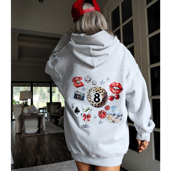 Unleash your inner luck and style with our Leopard 8 Ball Lucky Collage Hoodie. This trendy hoodie features a unique design of animal print, lucky symbols, and y2k style elements like dice, cherries, and disco balls. Perfect for a preppy aesthetic look, size up for an oversized fit.