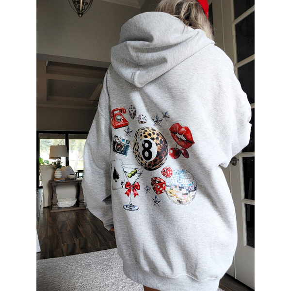 Unleash your inner luck and style with our Leopard 8 Ball Lucky Collage Hoodie. This trendy hoodie features a unique design of animal print, lucky symbols, and y2k style elements like dice, cherries, and disco balls. Perfect for a preppy aesthetic look, size up for an oversized fit.