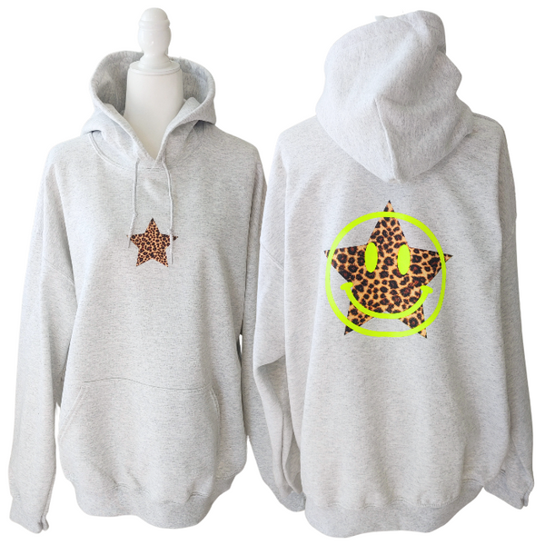 Add a pop of personality to your closet with this neon leopard star smiley hoodie! This cozy, lightweight graphic sweatshirt is the perfect blend of Y2K aesthetic, preppy style, and fun vibes. Featuring a bold neon yellow happy face and an animal print star, it's made to stand out from the crowd. Want that trendy oversized look? Size up from your usual size for the perfect slouchy fit! Perfect for summer nights, beach trips, or lounging in style. Makes a great gift for her too!