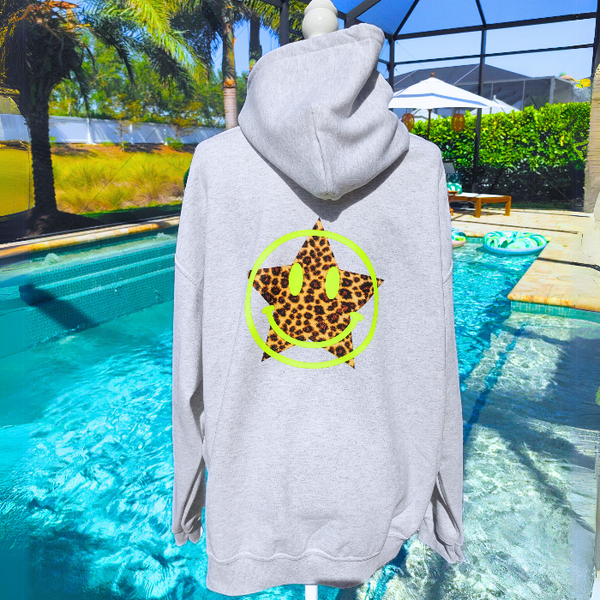 Add a pop of personality to your closet with this neon leopard star smiley hoodie! This cozy, lightweight graphic sweatshirt is the perfect blend of Y2K aesthetic, preppy style, and fun vibes. Featuring a bold neon yellow happy face and an animal print star, it's made to stand out from the crowd. Want that trendy oversized look? Size up from your usual size for the perfect slouchy fit! Perfect for summer nights, beach trips, or lounging in style. Makes a great gift for her too!