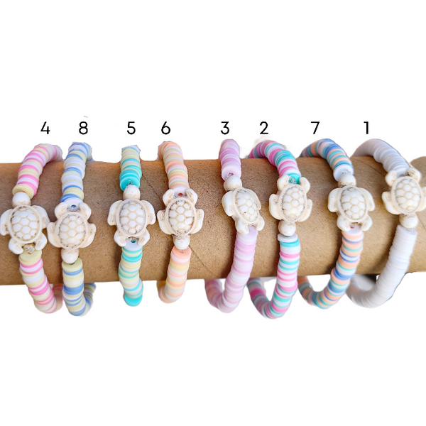 The Preppy Turtle Bracelet is perfect for summer! This eye-catching accessory features colorful Heishi clay beads and stone turtle bead to create an ocean-inspired look. It's perfect for stacking or gifting to someone special. With its unique design and mix of colors, this stretch bracelet is sure to stand out!