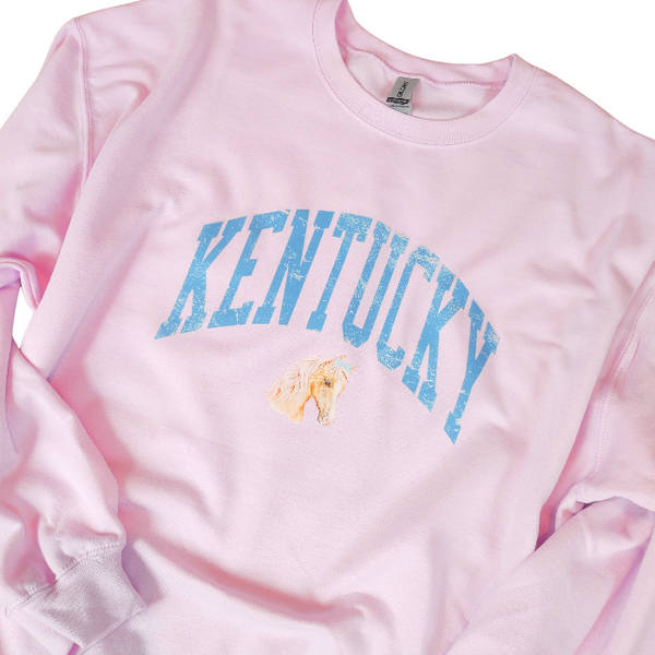 Stay cozy and stylish with our Kentucky sweatshirt, available in light pink and white! Featuring a cute coquette preppy horse with a bow, this distressed design is perfect for any horse lover or cowgirl. Ideal for a Kentucky derby outfit or as a gift, size up for an oversized fit. Order now and show off your love for all things western!