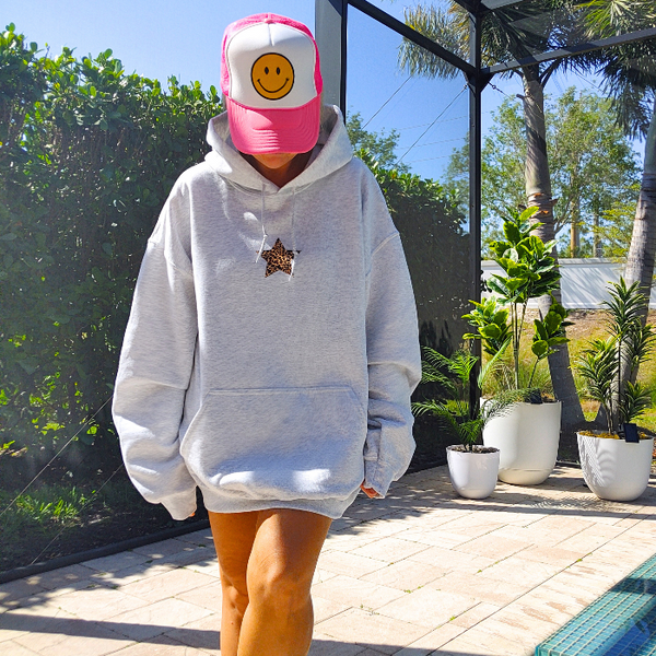 Add a pop of personality to your closet with this neon leopard star smiley hoodie! This cozy, lightweight graphic sweatshirt is the perfect blend of Y2K aesthetic, preppy style, and fun vibes. Featuring a bold neon yellow happy face and an animal print star, it's made to stand out from the crowd. Want that trendy oversized look? Size up from your usual size for the perfect slouchy fit! Perfect for summer nights, beach trips, or lounging in style. Makes a great gift for her too!
