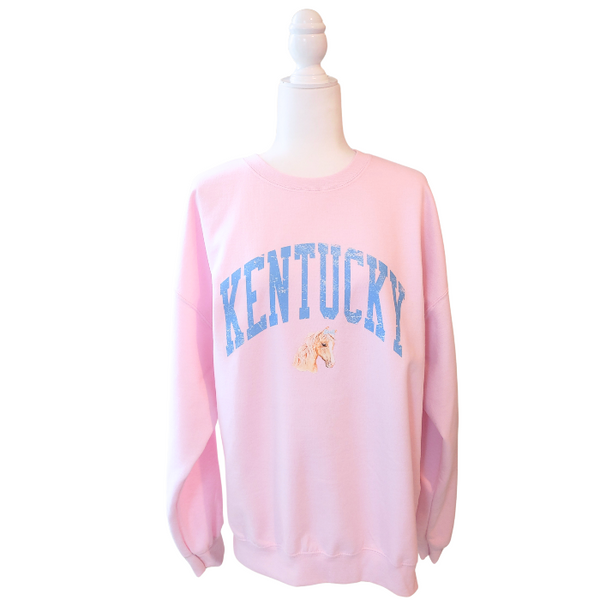 Stay cozy and stylish with our Kentucky sweatshirt, available in light pink and white! Featuring a cute coquette preppy horse with a bow, this distressed design is perfect for any horse lover or cowgirl. Ideal for a Kentucky derby outfit or as a gift, size up for an oversized fit. Order now and show off your love for all things western!