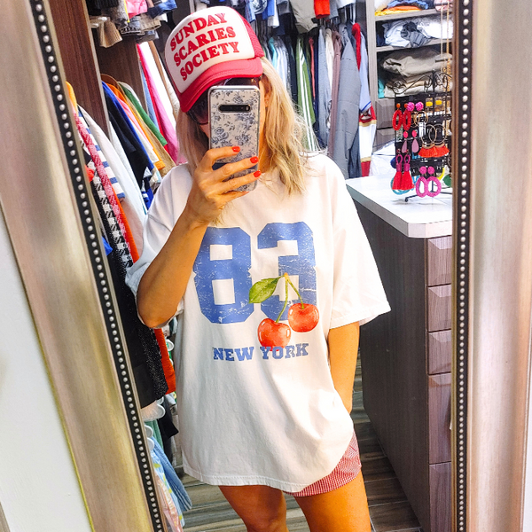 Introducing our 80's inspired Retro Sporty Shirt, featuring a vibrant Cherry graphic design and a nod to the iconic New York City. This trendy top is perfect for the preppy aesthetic and a must-have for any sports lover. Available in comfort color t-shirts and Gildan crewneck sweatshirts, size up for an oversized fit.