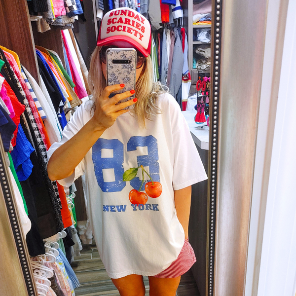 Introducing our 80's inspired Retro Sporty Shirt, featuring a vibrant Cherry graphic design and a nod to the iconic New York City. This trendy top is perfect for the preppy aesthetic and a must-have for any sports lover. Available in comfort color t-shirts and Gildan crewneck sweatshirts, size up for an oversized fit.