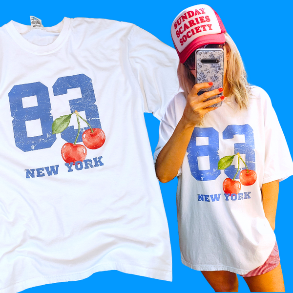Introducing our 80's inspired Retro Sporty Shirt, featuring a vibrant Cherry graphic design and a nod to the iconic New York City. This trendy top is perfect for the preppy aesthetic and a must-have for any sports lover. Available in comfort color t-shirts and Gildan crewneck sweatshirts, size up for an oversized fit.