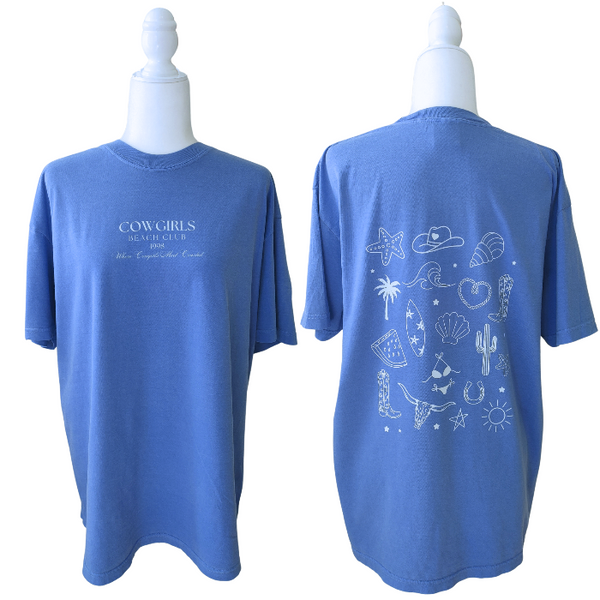 This Cowgirls Coastal Beach Club Graphic Tee is the perfect blend of western charm and summer style! This blue tee features a minimal front text and a fun beachy western graphic on the back—designed for trend-lovers and sunshine-chasers. Great for pairing with denim shorts, cowboy boots, or a trucker hat for the full cowgirl vibe. For that oversized, slouchy look, size up!