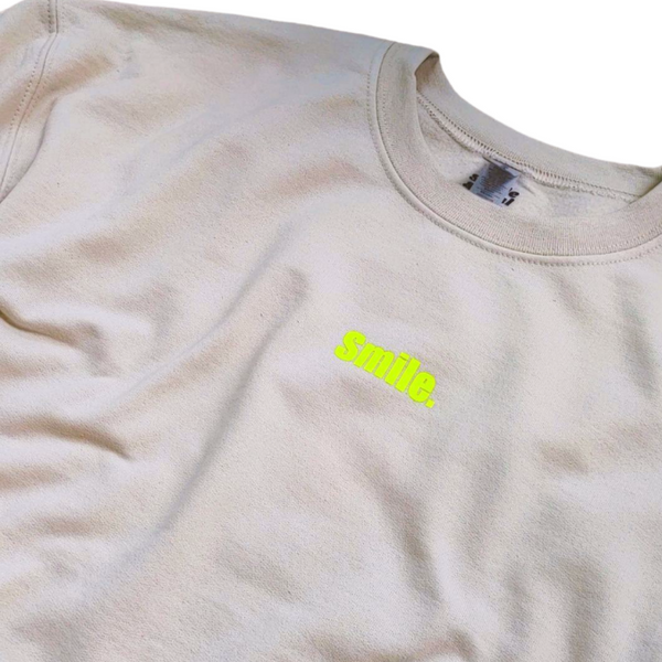 Neon Yellow Smiley Face Sweatshirt in the color Sand.