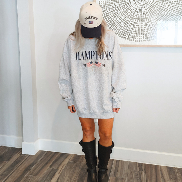Get ready to show off your vacation vibes with our Hamptons American Flag Sweatshirt! This trendy and preppy sweatshirt features a bold and oversized graphic design, perfect for those summer beach days. Made with a comfy blend of 50% cotton and 50% polyester, it's the perfect addition to your wardrobe. Size up for an even more oversized fit. Live your best Hamptons life in style.