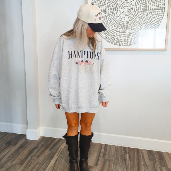 Get ready to show off your vacation vibes with our Hamptons American Flag Sweatshirt! This trendy and preppy sweatshirt features a bold and oversized graphic design, perfect for those summer beach days. Made with a comfy blend of 50% cotton and 50% polyester, it's the perfect addition to your wardrobe. Size up for an even more oversized fit. Live your best Hamptons life in style.