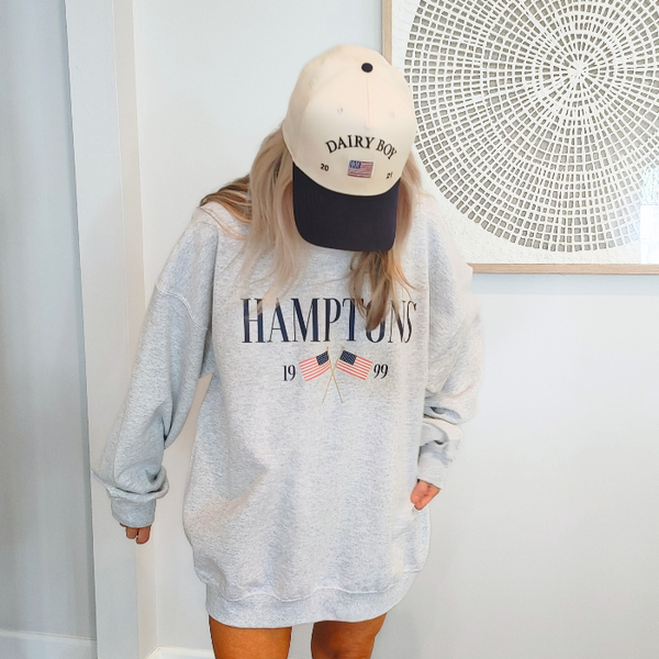 Get ready to show off your vacation vibes with our Hamptons American Flag Sweatshirt! This trendy and preppy sweatshirt features a bold and oversized graphic design, perfect for those summer beach days. Made with a comfy blend of 50% cotton and 50% polyester, it's the perfect addition to your wardrobe. Size up for an even more oversized fit. Live your best Hamptons life in style.