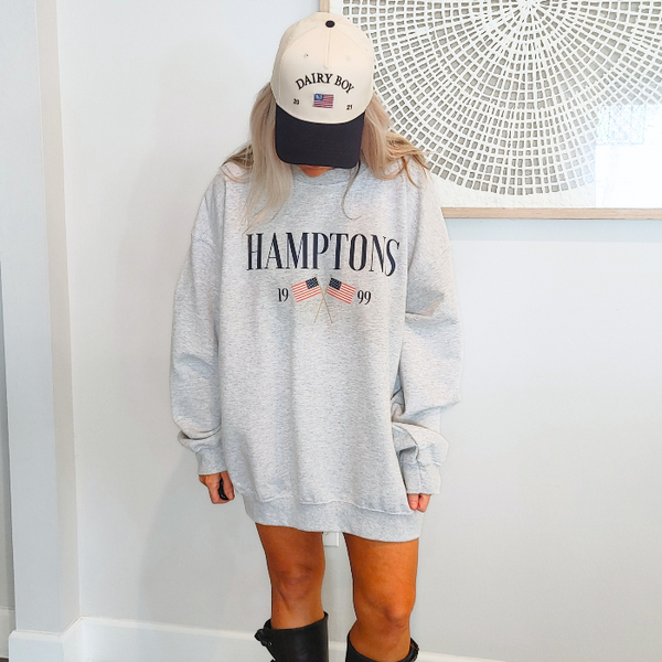 Get ready to show off your vacation vibes with our Hamptons American Flag Sweatshirt! This trendy and preppy sweatshirt features a bold and oversized graphic design, perfect for those summer beach days. Made with a comfy blend of 50% cotton and 50% polyester, it's the perfect addition to your wardrobe. Size up for an even more oversized fit. Live your best Hamptons life in style.