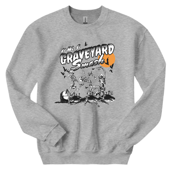 This Halloween, make a statement with our Halloween graveyard smash dancing skeleton t-shirt! Featuring a retro skeleton design, this shirt is perfect for the spooky season and will add a touch of vintage style to your fall wardrobe. Available in both comfort color t-shirts and Gildan crewneck sweatshirts, size up for an oversized fit. Get yours today!