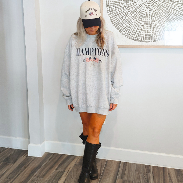 Get ready to show off your vacation vibes with our Hamptons American Flag Sweatshirt! This trendy and preppy sweatshirt features a bold and oversized graphic design, perfect for those summer beach days. Made with a comfy blend of 50% cotton and 50% polyester, it's the perfect addition to your wardrobe. Size up for an even more oversized fit. Live your best Hamptons life in style.