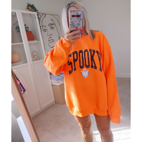 Unleash your spooky style with our Spooky Ghost Sweatshirt! Featuring a cute ghost with the word SPOOKY in varsity lettering and a distressed design, this sweatshirt is perfect for Halloween parties and the entire spooky season. Size up for an oversized fit. Get yours today and join the ghost squad!