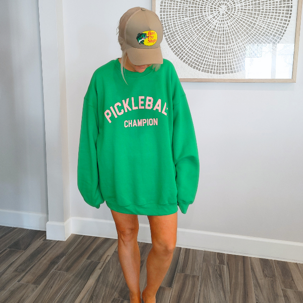 This Pickleball Champion Sweatshirt is an ideal preppy gift for any pickleball lover! Its fashionable and comfortable, making it the perfect choice for a trendy game day look. Whether you're heading to the court or just lounging around, you'll love showing your pickleball passion in this cute sweatshirt.