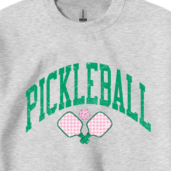 Ready to serve up some serious style? This distressed green and pink pickleball sweatshirt is the perfect gift for any pickleball lover or team. Made with a comfy 50/50 cotton-polyester blend, size up for an oversized fit and dominate the court with a preppy and trendy look.