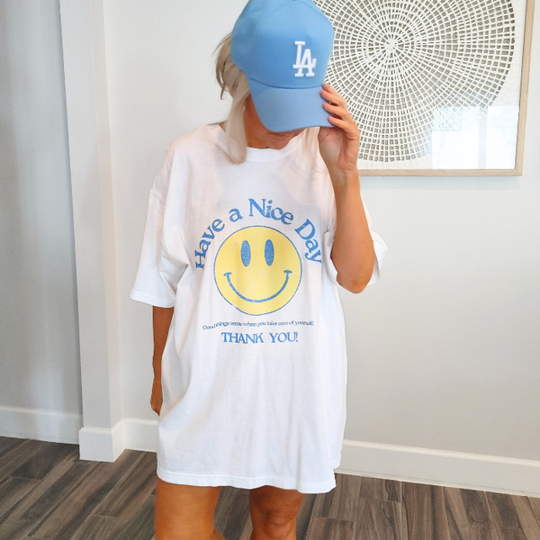 Spread positivity with our retro distressed vintage inspired smile face t-shirt. This 70s style shirt features a trendy, positive design and is available in both comfort color t-shirts and Gildan crewneck sweatshirts. Size up for an oversized, preppy aesthetic look. Perfect for those looking to make a statement and spread happy vibes. Thank us later!