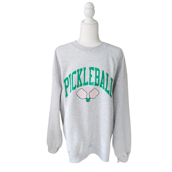 Ready to serve up some serious style? This distressed green and pink pickleball sweatshirt is the perfect gift for any pickleball lover or team. Made with a comfy 50/50 cotton-polyester blend, size up for an oversized fit and dominate the court with a preppy and trendy look.