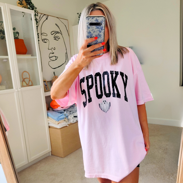 Introducing our Spooky Varsity Lettering Ghost T-Shirt, perfect for Halloween parties and spooky season. This distressed, design features a cute ghost and is available in comfort color t-shirts. Size up for an oversized, yet stylish fit. Make a statement with our exclusive Spooky Halloween Shirt.