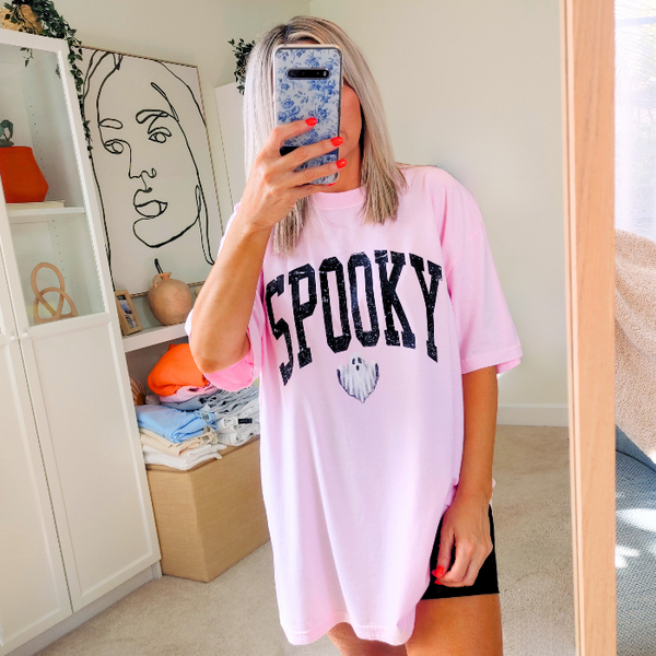 Introducing our Spooky Varsity Lettering Ghost T-Shirt, perfect for Halloween parties and spooky season. This distressed, design features a cute ghost and is available in comfort color t-shirts. Size up for an oversized, yet stylish fit. Make a statement with our exclusive Spooky Halloween Shirt.