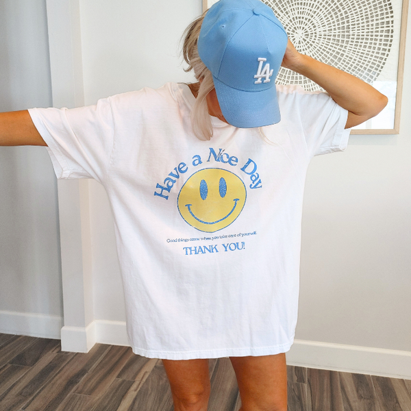 Spread positivity with our retro distressed vintage inspired smile face t-shirt. This 70s style shirt features a trendy, positive design and is available in both comfort color t-shirts and Gildan crewneck sweatshirts. Size up for an oversized, preppy aesthetic look. Perfect for those looking to make a statement and spread happy vibes. Thank us later!