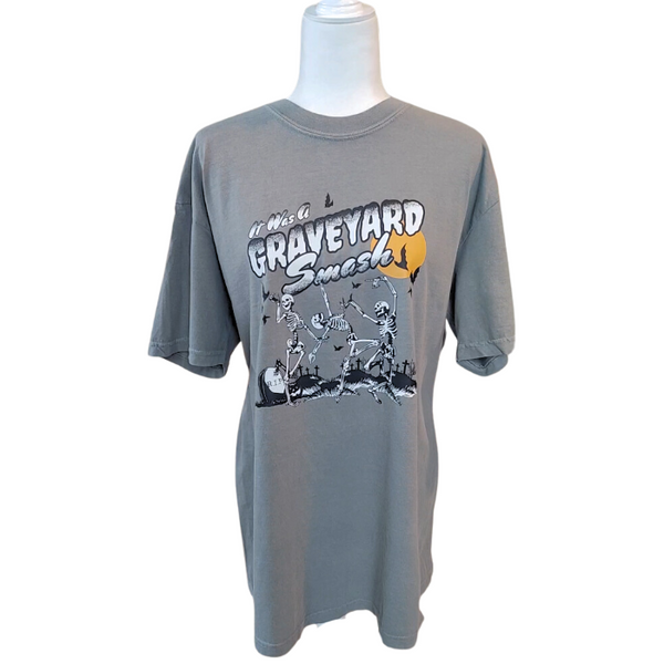 This Halloween, make a statement with our Halloween graveyard smash dancing skeleton t-shirt! Featuring a retro skeleton design, this shirt is perfect for the spooky season and will add a touch of vintage style to your fall wardrobe. Available in both comfort color t-shirts and Gildan crewneck sweatshirts, size up for an oversized fit. Get yours today!