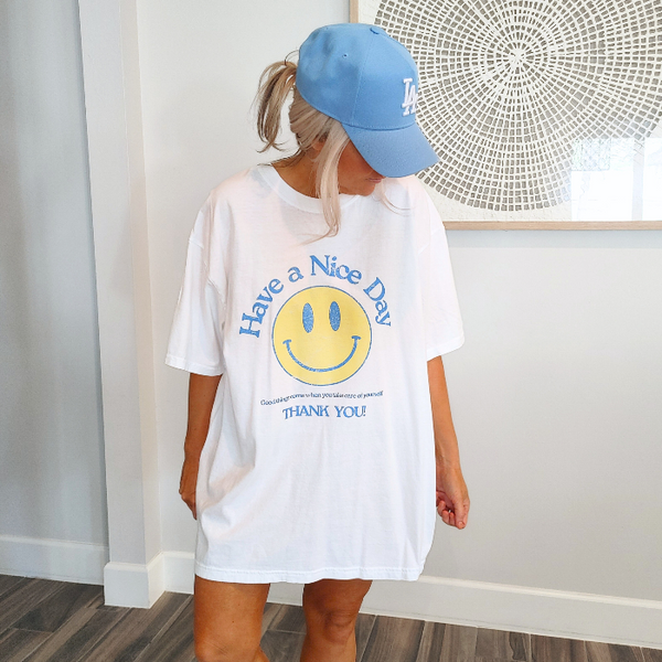 Spread positivity with our retro distressed vintage inspired smile face t-shirt. This 70s style shirt features a trendy, positive design and is available in both comfort color t-shirts and Gildan crewneck sweatshirts. Size up for an oversized, preppy aesthetic look. Perfect for those looking to make a statement and spread happy vibes. Thank us later!
