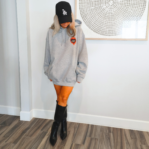 Turn up the western vibes with this Cowboys flame hoodie sweatshirt, featuring a bold flaming heart “Cowboys” graphic that makes a statement from every angle. Designed on a classic sports gray pullover hoodie, this piece blends edgy cowgirl style with everyday comfort—perfect for casual wear, concerts, or laid-back weekends.

This hoodie is made with a soft and cozy 50% cotton / 50% polyester blend, giving it warmth without feeling heavy. 