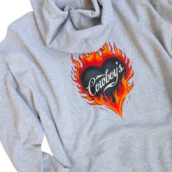 Turn up the western vibes with this Cowboys flame hoodie sweatshirt, featuring a bold flaming heart “Cowboys” graphic that makes a statement from every angle. Designed on a classic sports gray pullover hoodie, this piece blends edgy cowgirl style with everyday comfort—perfect for casual wear, concerts, or laid-back weekends.

This hoodie is made with a soft and cozy 50% cotton / 50% polyester blend, giving it warmth without feeling heavy. 