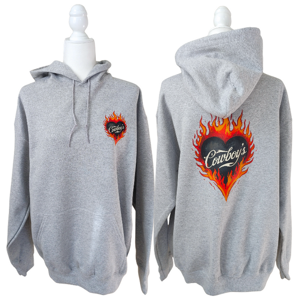 Turn up the western vibes with this Cowboys flame hoodie sweatshirt, featuring a bold flaming heart “Cowboys” graphic that makes a statement from every angle. Designed on a classic sports gray pullover hoodie, this piece blends edgy cowgirl style with everyday comfort—perfect for casual wear, concerts, or laid-back weekends.

This hoodie is made with a soft and cozy 50% cotton / 50% polyester blend, giving it warmth without feeling heavy. 