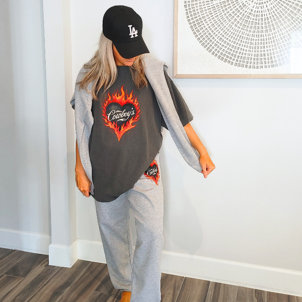Turn up the heat with this Cowboys flame graphic t-shirt, designed for effortless western style with a modern, trendy edge. This vintage-inspired tee features a bold flaming heart “Cowboys” graphic on a rich pepper-colored base, giving it that worn-in, lived-in look everyone loves.