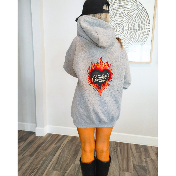 Turn up the western vibes with this Cowboys flame hoodie sweatshirt, featuring a bold flaming heart “Cowboys” graphic that makes a statement from every angle. Designed on a classic sports gray pullover hoodie, this piece blends edgy cowgirl style with everyday comfort—perfect for casual wear, concerts, or laid-back weekends.

This hoodie is made with a soft and cozy 50% cotton / 50% polyester blend, giving it warmth without feeling heavy. 