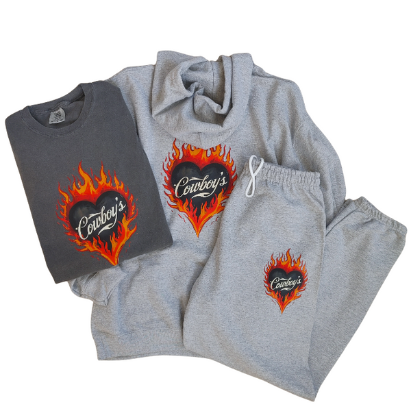 Turn up the heat with this Cowboys flame graphic t-shirt, designed for effortless western style with a modern, trendy edge. This vintage-inspired tee features a bold flaming heart “Cowboys” graphic on a rich pepper-colored base, giving it that worn-in, lived-in look everyone loves.