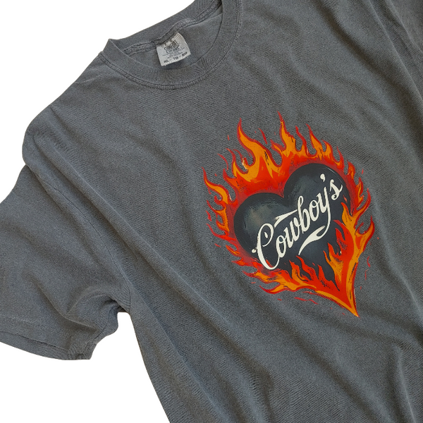 Turn up the heat with this Cowboys flame graphic t-shirt, designed for effortless western style with a modern, trendy edge. This vintage-inspired tee features a bold flaming heart “Cowboys” graphic on a rich pepper-colored base, giving it that worn-in, lived-in look everyone loves.