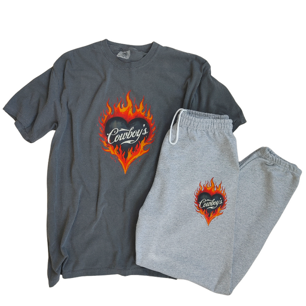 Bring bold western energy to your everyday wardrobe with these Cowboys flame sweatpants. Featuring a striking flaming heart “Cowboys” graphic, these gray jogger-style sweatpants are designed for laid-back comfort with a statement edge. They have an oversized fit for that relaxed, effortlessly look. They feature a drawstring elastic waistband and elastic cuffs for all-day comfort and an easy fit.