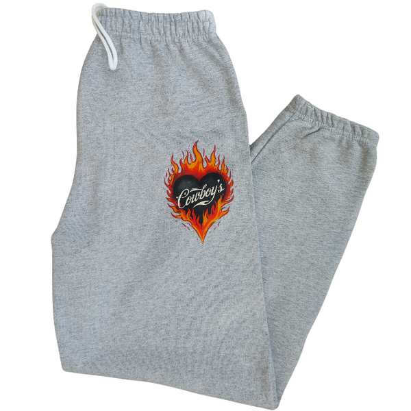 Bring bold western energy to your everyday wardrobe with these Cowboys flame sweatpants. Featuring a striking flaming heart “Cowboys” graphic, these gray jogger-style sweatpants are designed for laid-back comfort with a statement edge. They have an oversized fit for that relaxed, effortlessly look. They feature a drawstring elastic waistband and elastic cuffs for all-day comfort and an easy fit.