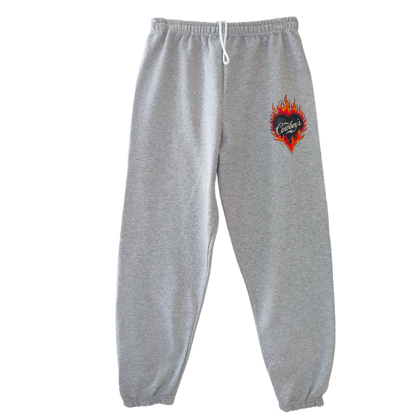 Bring bold western energy to your everyday wardrobe with these Cowboys flame sweatpants. Featuring a striking flaming heart “Cowboys” graphic, these gray jogger-style sweatpants are designed for laid-back comfort with a statement edge. They have an oversized fit for that relaxed, effortlessly look. They feature a drawstring elastic waistband and elastic cuffs for all-day comfort and an easy fit.