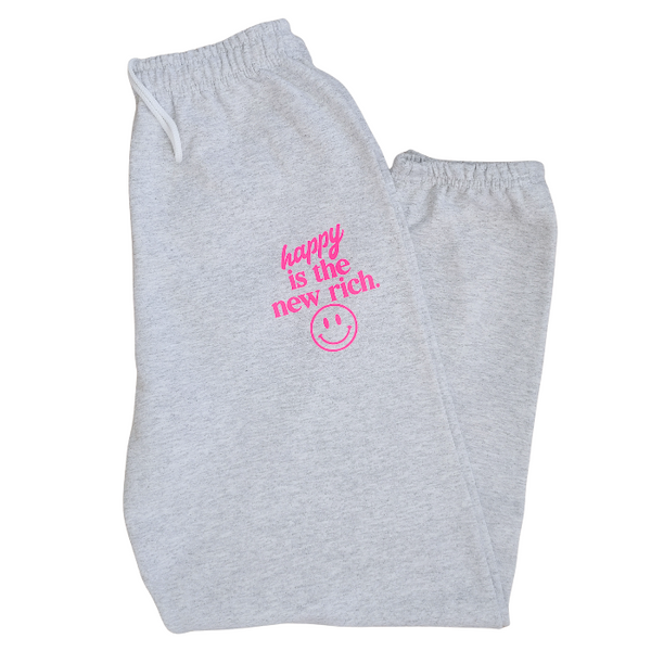 Bring all the happy vibes with this trendy “Happy Is the New Rich” loungewear set. Designed with a bold neon-pink graphic and a preppy, on-trend style, this matching sweatshirt and sweatpants outfit is the perfect blend of cozy comfort and feel-good energy. The sweatshirt is soft, relaxed, and features the neon-pink “Happy Is the New Rich” design on the front with a large smiley face graphic on the back. If you want that oversized, stylish, slouchy look, we recommend sizing up for the perfect relaxed fit. T
