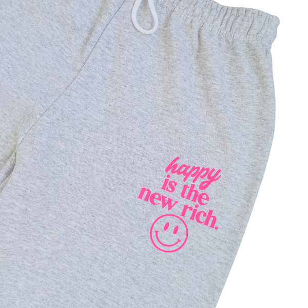 Bring all the happy vibes with this trendy “Happy Is the New Rich” loungewear set. Designed with a bold neon-pink graphic and a preppy, on-trend style, this matching sweatshirt and sweatpants outfit is the perfect blend of cozy comfort and feel-good energy. The sweatshirt is soft, relaxed, and features the neon-pink “Happy Is the New Rich” design on the front with a large smiley face graphic on the back. If you want that oversized, stylish, slouchy look, we recommend sizing up for the perfect relaxed fit. T