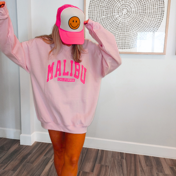 Our super soft pink Malibu crewneck is a great stylish and trendy piece. The Malibu California sweatshirt is perfect for layering or wearing alone for a casual look. With neon pink lettering, this sweatshirt is preppy in style and also makes the perfect gift! Don't forget to size up for an oversized trendy look.