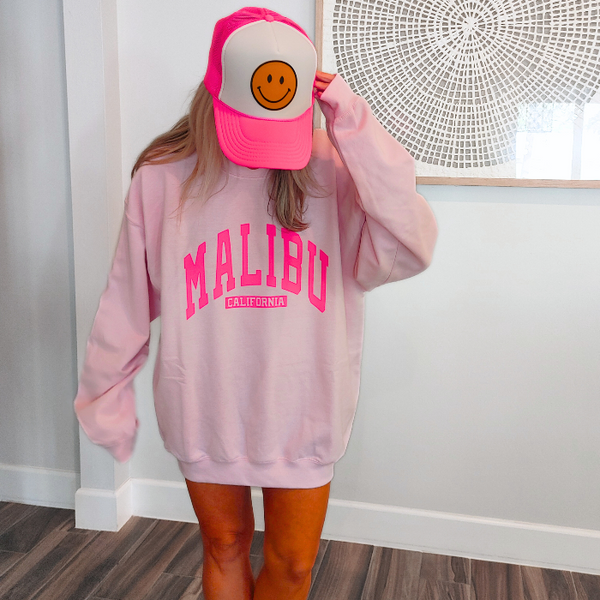 Our super soft pink Malibu crewneck is a great stylish and trendy piece. The Malibu California sweatshirt is perfect for layering or wearing alone for a casual look. With neon pink lettering, this sweatshirt is preppy in style and also makes the perfect gift! Don't forget to size up for an oversized trendy look.