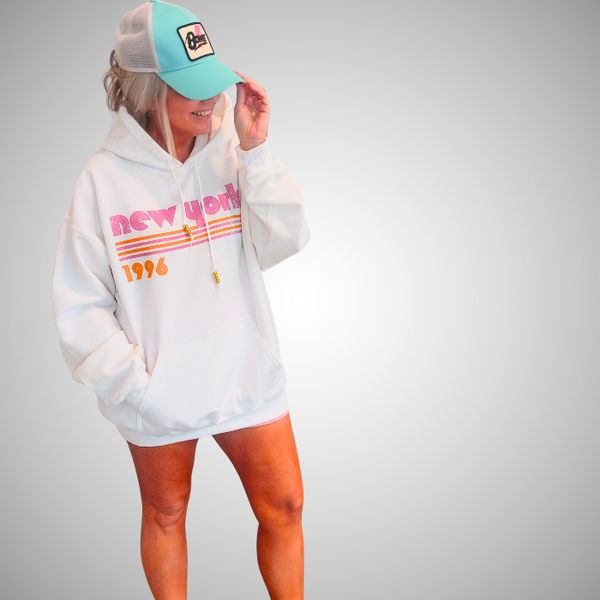 This New York Hoodie is the perfect blend of retro style and everyday comfort. Featuring a distressed New York graphic with vibrant pink and orange stripes, metallic gold beaded drawstrings, and a cozy unisex fit, it's a statement hoodie made for city lovers, travelers, and anyone who loves a bold vintage-inspired aesthetic. Size up 1–2 sizes for a cozy oversized look.