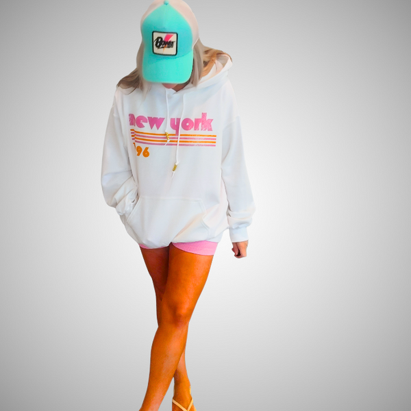 This New York Hoodie is the perfect blend of retro style and everyday comfort. Featuring a distressed New York graphic with vibrant pink and orange stripes, metallic gold beaded drawstrings, and a cozy unisex fit, it's a statement hoodie made for city lovers, travelers, and anyone who loves a bold vintage-inspired aesthetic. Size up 1–2 sizes for a cozy oversized look.