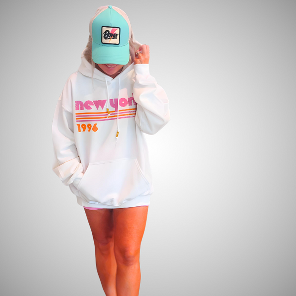 This New York Hoodie is the perfect blend of retro style and everyday comfort. Featuring a distressed New York graphic with vibrant pink and orange stripes, metallic gold beaded drawstrings, and a cozy unisex fit, it's a statement hoodie made for city lovers, travelers, and anyone who loves a bold vintage-inspired aesthetic. Size up 1–2 sizes for a cozy oversized look.