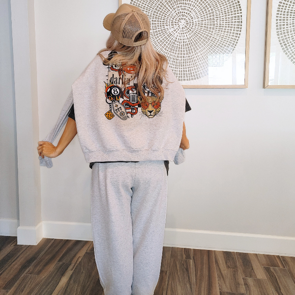 Bring bold retro energy to your wardrobe with this 3-piece vintage Western tattoo graphic set, including a cozy sweatshirt, Comfort Colors tee, and matching flame-dice sweatpants.